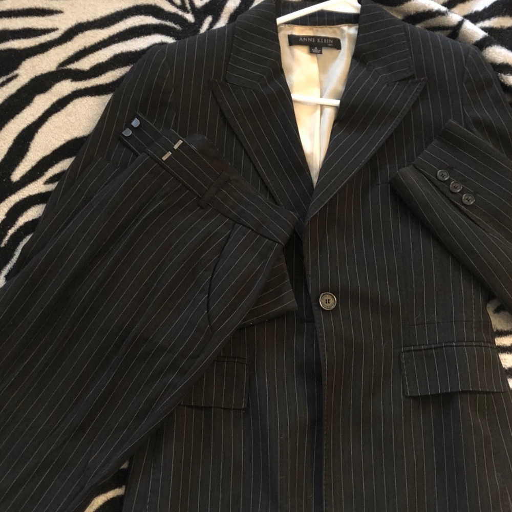 Black pin-stripe pants suit.